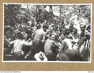 FINSCHHAFEN, NEW GUINEA. 1943-12-25. A GENERAL VIEW OF THE MEN'S MESS AT HEADQUARTERS 9TH DIVISION DURING THE CHRISTMAS DINNER