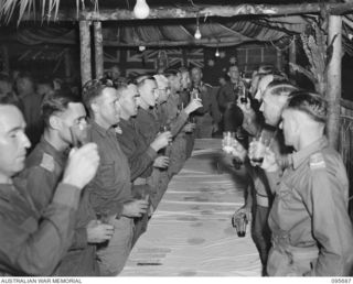 TOKO, BOUGAINVILLE. 1945-08-28. TOAST TO THE KING DURING THE DINNER HELD BY HEADQUARTERS 3 DIVISION STAFF OFFICERS TO CELEBRATE VICTORY OVER JAPAN. IT WAS ATTENDED BY MAJOR GENERAL W. BRIDGEFORD, ..