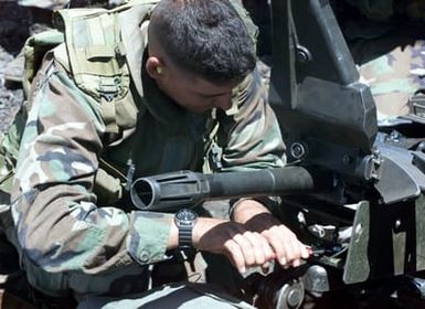 US Marine Corps Sergeant Hobbs from 1ST battalion, 3rd Marines, Weapons Company, adjusts an MK-19 during a training exercise at Pohakuloa Training Area on the Big Island of Hawaii