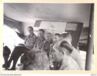 CAPE WOM, NEW GUINEA. 1945-10-20. CORPS OF AUSTRALIAN ELECTRICAL AND MECHANICAL ENGINEERS OFFICERS ATTENDING THE WEEKLY CONFERENCE AT HEADQUARTERS 6 DIVISION. AT THIS CONFERENCE WORK IS REVIEWED, ..