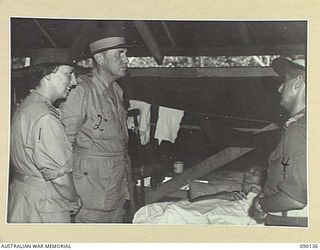 BOUGAINVILLE. 1945-03-31. LORD WAKEHURST, GOVERNOR OF NEW SOUTH WALES (2), AND LADY WAKEHURST (1), SPEAKING WITH GUNNER W. GRAY, 4 FIELD REGIMENT (3), IN THE ADVANCED DRESSING STATION DURING THEIR ..