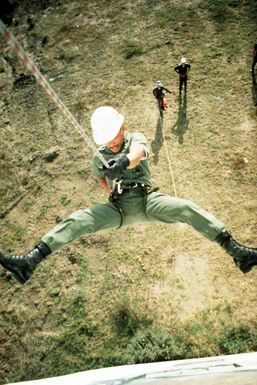 CHIEF Steelworker Ignacio P. Lopez rappels from a wall during a Civic Action Team training exercise. The team, composed of United States Navy construction battalion members, is deployed to the island of Yap to aid villagers with construction projects and offer vocational training