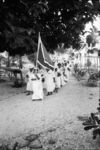 Women's Day procession to church. Petesa as flag bearer.