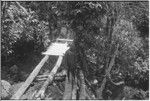 Bridge-building: men place planks for deck