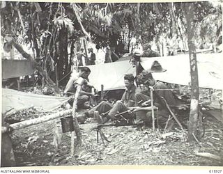 1943-10-06. NEW GUINEA. ATTACK ON LAE. THIS PLATOON OF FAMOUS AUSTRALIAN BATTALION TOOK PART IN THE VICTORIOUS ADVANCE ON LAE. THEY INFLICTED HEAVY CASUALTIES ON THE JAPANESE. IN THE BACKGROUND ..