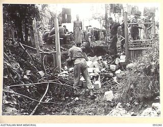 WEWAK AREA, NEW GUINEA, 1945-06-17. IN A JAPANESE SHRINE ON THE KOIGIN TRACK, 4,000 URNS WERE DISCOVERED, EACH CONTAINING THE ASHES OF A JAPANESE SOLDIER. THE URNS, CUBE SHAPED AND APPROXIMATELY 3 ..