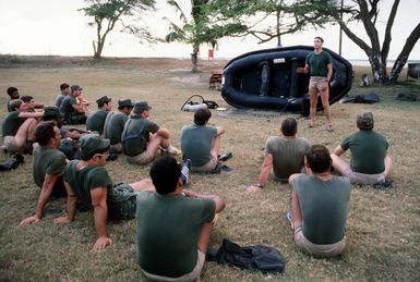 Combat control team members being instructed by Marines of the 4th Force Reconnaissance Group, on the use of the Inflatable Small Boat (ISB)