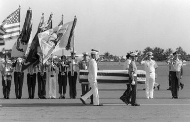 A joint service honor guard carries a casket containing the remains of an unidentified serviceman who was killed in Vietnam past a joint service color guard during an arrival ceremony at the base