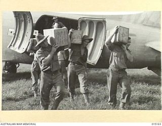 1943-06-29. NEW GUINEA. WAU-MUBO AREA. TRANSPORT PLANES UNLOADING AT AN ADVANCED LANDING GROUND. (NEGATIVE BY G. SHORT)