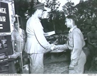 THE SOLOMON ISLANDS, 1945-01-12. CONGRATULATIONS TO A WINNER AT A COMBINED ANZAC SPORTS MEETING AT BOUGAINVILLE ISLAND. (RNZAF OFFICIAL PHOTOGRAPH.)