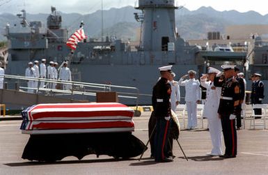 Marine Sergeant Major Allan J. Kellogg, right, Medal of Honor recipient for duty in Vietnam, and Air Force General Jerome O'Malley, commander-in-chief of Pacific Air Forces, salute during the wreath-laying ceremony to honor the Unknown Serviceman of the Vietnam Era. The casket will be transported California aboard the frigate USS BREWTON (FF 1086)