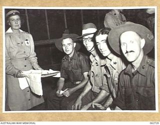 SYDNEY, NSW. 1944-01-12. HOSPITAL CASES FROM NEW GUINEA WHO HAVE JUST ARRIVED AT THE GENERAL DETAILS DEPOT, BEING SERVED WITH TEA BY V. A. SPENCE, AUSTRALIAN RED CROSS VOLUNTARY AID DETACHMENT. ..