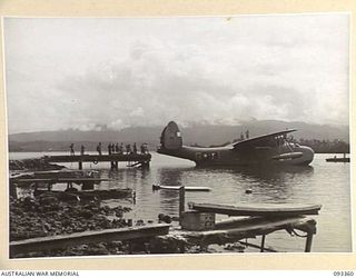 PALMALMAL PLANTATION, NEW BRITAIN, 1945-06-23. A MARTIN MARINER FLYING BOAT OF THE RAAF BEING BACKED INTO THE WHARF WITH ADVANCE PARTY OF HQ 11 DIVISION ON BOARD. THE ADVANCE PARTY WILL TAKE OVER ..