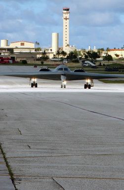 A US Air Force (USAF) 325th Bomb Squadron (BS), 509th Bomb Wing (BW), B-2 Spirit multi-role stealth bomber, from Whiteman Air Force Base (AFB), Missouri (MO), taxis onto the flight line at Andersen AFB, Guam (GU), as it participates in Exercise CORONET BUGLE 49, which is part of an Air Combat Command (ACC) Global Power mission