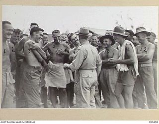 BUT-DAGUA AREA, NEW GUINEA. 1945-04-12. SENATOR J.M. FRASER, ACTING MINISTER FOR THE ARMY (13), WITH 16 INFANTRY BRIGADE PERSONNEL ON THE BEACH DURING HIS VISIT TO HEADQUARTERS 6 DIVISION AREA WITH ..