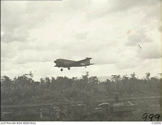 AITAPE, NORTH EAST NEW GUINEA. 1944-04-25. FIRST DOUGLAS TRANSPORT AIRCRAFT PREPARES TO LAND ON THE NEW TADJI AIRSTRIP BUILT BY ENGINEERS OF NO. 62 WORKS WING RAAF