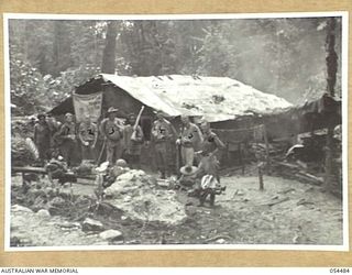 NEW GUINEA, 1943-07-20. SALVATION ARMY HUT AT NEIL'S CREEK. EUROPEANS, LEFT TO RIGHT:- VX106247 PRIVATE V.R. HAMILTON; 3RD AUSTRALIAN DIVISION SALVAGE UNIT; VX106283 SIGNALLER R.L. GUNN, 3RD ..