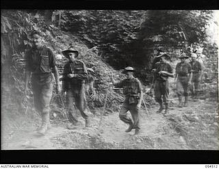 Mubo-Salamaua Area, New Guinea. 1943-07-21. Six men of the 2/5th Australian Infantry Battalion, AIF, who were injured in action at Mount Tambu and Tambu Saddle areas walking wounded on their way to ..