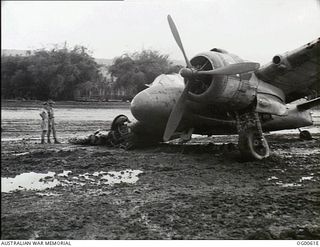 MILNE BAY, PAPUA. C. 1942-10. A DAMAGED BEAUFIGHTER AIRCRAFT OF NO. 30 SQUADRON RAAF WHICH HAD COLLIDED WITH A HUDSON BOMBER AIRCRAFT OF NO. 6 SQUADRON RAAF WHILE LANDING ON THE MUDDY GURNEY ..