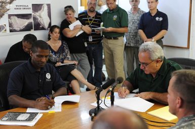 Earthquake ^ Tsunami - Pago Pago, American Samoa, October 6, 2009 -- Federal Coordinating Officer Kenneth Tingman and American Samoa Governor Togiola Tulafono sign a memorandum of agreement. The memorandum outlines the roles and responsibilities between the territory and the Federal Emergency Management Agency in disaster recovery.