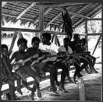 Group of children with guitars and ukuleles