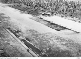 TOBERA, NEW BRITAIN. ? 1944-03. MAKING A RUN DOWN THE AIRSTRIP. NOTE, JAPANESE USING LIGHT RAILWAY FROM PLANTATION FOR CARRYING SUPPLIES. FOXHOLE FULL OF NIPS (JAPANESE) IN BOTTOM LEFT CORNER. ..