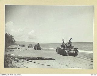 Matilda tanks of  C Squadron, 2/4 Armoured Regiment, rumble along the beach at Kofi village, in New Guinea, on route for Karawop plantation where they will continue their role of support for the ..