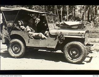 Dumpu, New Guinea. 1943-12-10. N102659 Sergeant H. Riley, Operator, (driver) and VX145795 Lance Sergeant E. W. Franklin, Assistant Operator, both of the 85th Australian Mobile Cinema Unit, 7th ..