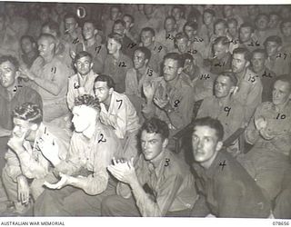 LAE AREA, NEW GUINEA. 1945-01-28. A SECTION OF THE AUDIENCE APPLAUDING DURING A SHOW STAGED BY THE DICK BENTLEY CONCERT PARTY AT HEADQUARTERS, 1ST AUSTRALIAN ARMY