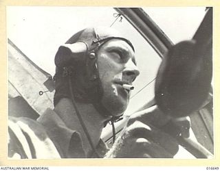 NEW GUINEA. 6 MARCH 1944. THE SQUADRON LEADER H. C. PLENTY DFC (IN HELMET), WHO LED THE FORMATION OF BEAUFORT AIRCRAFT OF NO. 100 SQUADRON RAAF IN A SUCCESSFUL RAID AGAINST NEW BRITAIN, TAKES A ..