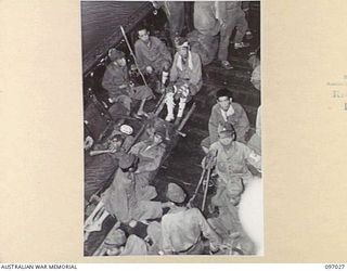 JAPANESE SICK AND WOUNDED IN A BARGE ALONGSIDE THE DEBORAH, FOR EVACUATION FROM NUMA NUMA TO TOROKINA. THESE MOVES FOLLOW THE ARRIVAL AT NUMA NUMA PLANTATION OF MEMBERS OF THE AUSTRALIAN SURRENDER ..