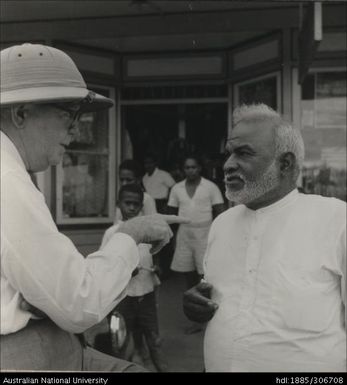 Officer speaking with Indian man