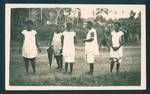 Group of women at sing-sing, in background are young men, Rabaul, New Guinea, c1929 to 1931