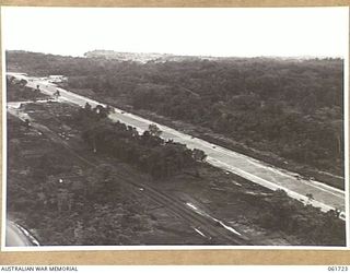 HUON PENINSULA, NEW GUINEA. 1943-12-05. A NEW AIRSTRIP BUILT AT AN ADVANCED POINT IN HEAVY WOODED COUNTRY ON THE COAST