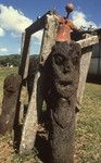 Carved tree fern statues with school bell