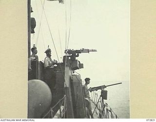 MADANG, NEW GUINEA, 1944-04-30. LIEUTENANT W. SHIPWAY (1), SUB-LIEUTENANT BLACK (2), AND ABLE SEAMAN FERGUSON (3), MAINTAIN WATCH ON THE BRIDGE OF HMA MOTOR LAUNCH 424, A FAIRMILE SUBMARINE CHASER, ..