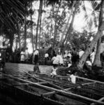 Men assembled around the vaka (coffin)