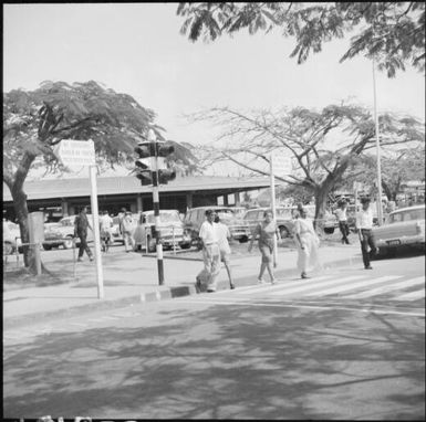 Pedestrians crossing street with traffic lights, Fiji, November 1966 / Michael Terry