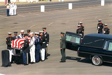 A joint services casket team places the casket of the Unknown Serviceman of the Vietnam Era on a bier during the designation and departure ceremony. After the ceremony, the Unknown will be placed aboard the frigate USS BREWTON (FF 1086) and transported to Naval Air Station Alameda, California