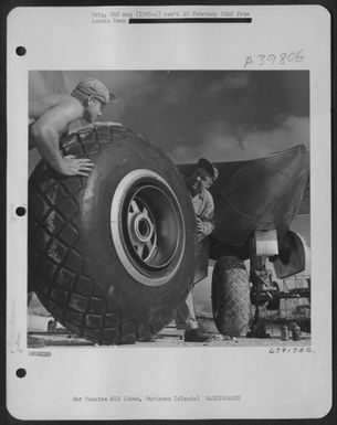 Ground Crew Members Change One Of The Huge Wheels On A Boeing B-29 "Superfortress" Based At North Field, Guam, Marianas Islands. 7 May 1945. (U.S. Air Force Number 67917AC)