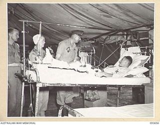 TOROKINA, BOUGAINVILLE, 1945-07-03. HIS ROYAL HIGHNESS, THE DUKE OF GLOUCESTER, GOVERNOR-GENERAL OF AUSTRALIA (3), SPEAKS WITH AIRCRAFTMAN 1 F. HAVIL, 31 SQUADRON ROYAL NEW ZEALAND AIR FORCE (4), A ..