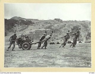 LAKONA, NEW GUINEA. 29 March 1944. A 2 POUNDER TANK ATTACK GUN CREW FROM THE 30TH INFANTRY BATTALION MOVING TO ACTION ON TRAINING EXERCISES. LEFT TO RIGHT: NX123688 CORPORAL J. E. STANES; NX164874 ..