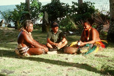 CHIEF Steelworker Ignacio P. Lopez converses with local villagers on the island of Yap. Lopez is a U.S. Navy construction battalion member assigned to a Civic Action Team deployed to the area to aid villagers with construction projects and offer vocational training