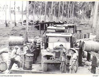 MADANG, NEW GUINEA. 1944-08-15. PERSONNEL OF THE 165TH GENERAL TRANSPORT COMPANY REFUELLING MOTOR VEHICLES AT THE UNIT PETROL POINT. IDENTIFIED PERSONNEL ARE:- NX154968 DRIVER E.F. MCGRATH (1); ..