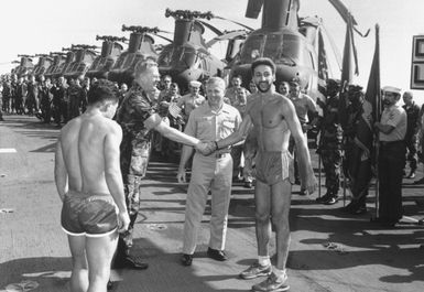 Colonel J. P. Faulkner, commanding officer of the 22nd MAU, congratulates Aviation Boastwain's Mate Fuels 3rd Class (ABF3) J. Deshaies as the Navy runner with the most Olympic spirit during the Guam's "Run Across the Atlantic". The trans-Alantic marathon began April 20th in Rota, Spain, and ended May 1st inside the 3-mile limit near Morehead City, North Carolina