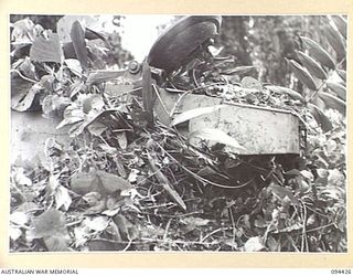 TOROKINA AREA, BOUGAINVILLE. 1945-07-28. AN M24 GENERAL CHAFFEE LIGHT TANK UNDERGOING TESTS FOR THE WAR OFFICE. IT SHOWS VINE CURLED ROUND THE TURRET MAKING IT HARD FOR HAND TRAVERSING. FROM THIS ..