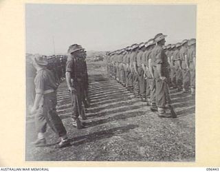 CAPE WOM, NEW GUINEA, 1945-09-13. TROOPS OF 6 DIVISION ON PARADE FOR THE SURRENDER CEREMONY HELD AT CAPE WOM AIRSTRIP WHERE LIEUTENANT-GENERAL H. ADACHI, COMMANDER 18 JAPANESE ARMY IN NEW GUINEA ..