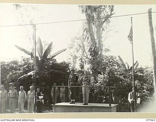 BOUGAINVILLE, 1944-11-21. MAJOR GENERAL O. GRISWOLD, COMMANDING GENERAL XIV CORPS, UNITED STATES ARMY (2) TAKING THE SALUTE AS AUSTRALIAN AND AMERICAN FLAGS WERE BROKEN AT THE SALUTING BASE DURING ..