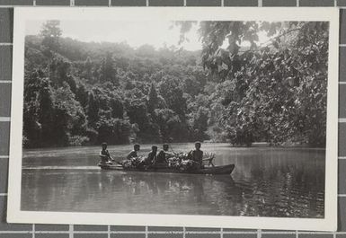 Papua New Guineans travelling by canoe