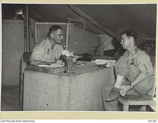 BOUGAINVILLE. 1945-04-26. PRIVATE E. ELLIOT, 9 INFANTRY BATTALION (2), HAVING A FINAL CHECK OVER AND CHAT WITH LIEUTENANT-COLONEL M.M. ROSEFIELD, COMMANDING OFFICER 2/3 CONVALESCENT DEPOT (1)